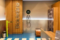 an office lobby with blue flooring and wooden signs on the wall, along with white striped walls