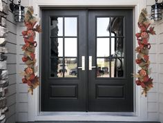 the front door is decorated with fall leaves