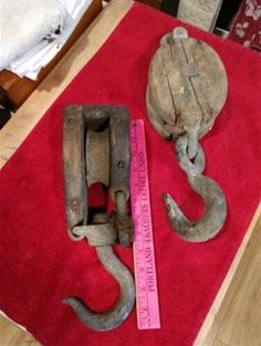 two pieces of metal sitting on top of a red rug