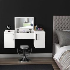 a bedroom with black walls and white furniture