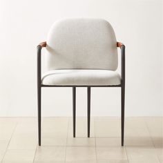 a white chair sitting on top of a tiled floor