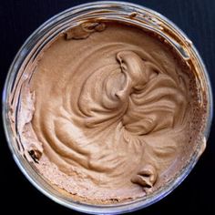 a bowl filled with chocolate frosting on top of a table