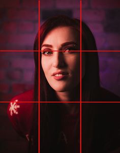 a woman looking at the camera through a grid