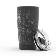 a travel mug with the lid open next to it on a white background, which features a map of boston