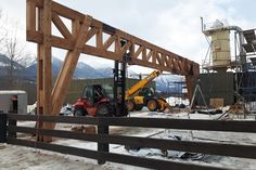 a forklift is parked in front of a construction site with mountains in the background