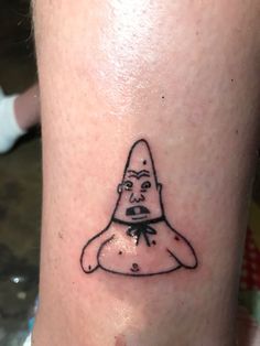 a tattoo on the leg of a person with a gnome hat and bow tie around his neck