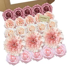 pink and white flowers in a cardboard box