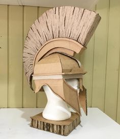 a helmet made out of cardboard sitting on top of a table