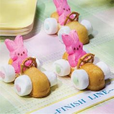 three little pink pigs riding on top of each other in tiny cars with wheels and bows