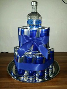 a cake made to look like an alcohol bottle with a blue bow on the top