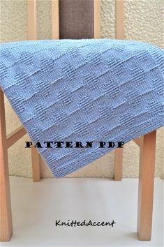 a blue blanket sitting on top of a wooden chair