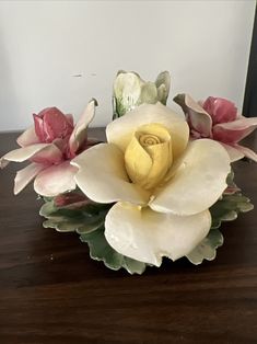 an arrangement of flowers is sitting on a table