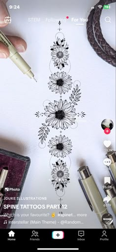 someone is drawing flowers on paper with a pen