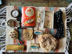 an assortment of jewelry is laid out on a blanket