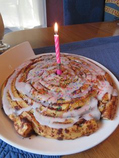 a birthday cake with a lit candle on top