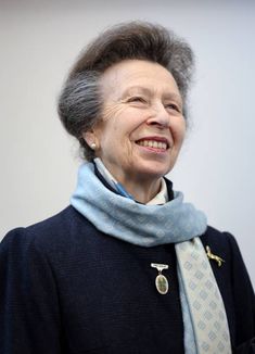 an older woman wearing a blue scarf and smiling