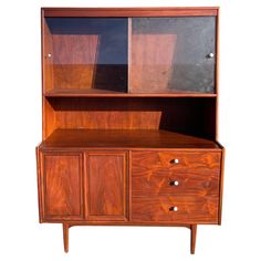 a wooden cabinet with two doors and drawers