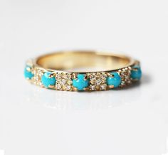 Round turquoise and diamond wedding band with tiny diamonds and cabochon turquoises. This design is available as a half eternity or full eternity band. Please select the design from the drop-down menu. The design can be made with gemstones of your choosing. If you would prefer a custom ring, please contact us before purchase. ★Details for a half eternity band Gemstones: round turquoise and white diamonds Turquoise measurements: approx. 3mm cabochon (5) Diamond measurements: approx. 1.1mm (20) Di Turquoise Band Ring, Fine Jewelry 14k Gold Turquoise Ring For Wedding, Round Turquoise Wedding Ring In Fine Jewelry Style, Turquoise And Diamond Wedding Band, Turwuoise Wedding Ring Stacker, Luxury Turquoise Diamond Ring, Elegant Style, Gold Turquoise Ring For Wedding, Fine Jewelry, Turquoise And Diamond Ring, Fairytale Vibes