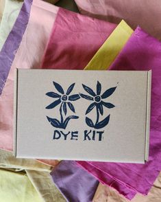 the dye kit is sitting on top of some fabric