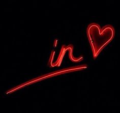 a neon sign that says i'm in the shape of a heart on a black background