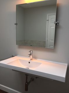 a bathroom sink with a mirror above it