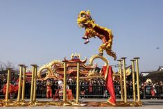 a large dragon statue in front of a crowd