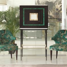 two chairs sitting next to each other in front of a mirror with a square design on it