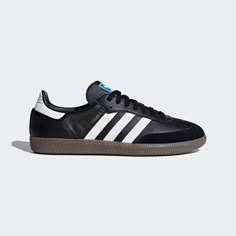 Born on the pitch, the Samba is a timeless icon of street style. This silhouette stays true to its legacy with a tasteful, low-profile, soft leather upper, suede overlays and gum sole, making it a staple in everyone's closet - on and off the pitch. Adidas Samba Black, Tap To, Samba Shoes, Just In, Sneaker Shop, Adidas Samba Og, Kaia Gerber, Black Gums, Retro Sneakers