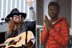 two men with hats and sunglasses on one has his hands in the air as he sings