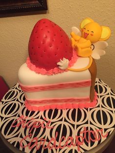 there is a cake on the table with an angel and strawberry