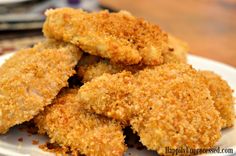 some fried food is on a white plate and ready to be eaten by someone else