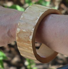 Treat yourself to the organic beauty of nature with these maple wood bracelets. Each is carefully hand cut and finished to bring out the natural color and texture of the origin tree. Wonderful to stack in a pair each of these is sold individually. A light coating of tung oil enhances the color of the wood. Medium size will fit an average adult hand, please select by number 4748 is 1 1/2" (38 mm) wide 4749 is 1 1/4" (33 mm) wide 7 3/4" (197 mm) inside circumference 2 1/2" (65 mm) inside diameter To facilitate placement slip a plastic bag on over the hand to reduce friction when sliding this bracelet in place.  This is one of a limited series of bark and burl bracelets crafted from a managed woodlot located in the driftless region of southwest Wisconsin. Please see the other listings in this Tung Oil, Wood Bracelet, Red Gift, Bracelet Crafts, Maple Wood, Organic Beauty, Bracelet Sizes, Bangle Bracelet, Plastic Bag