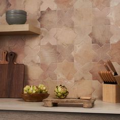 a kitchen counter topped with bowls and cutting boards