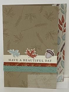 a greeting card with leaves and acorns on it, says have a beautiful day