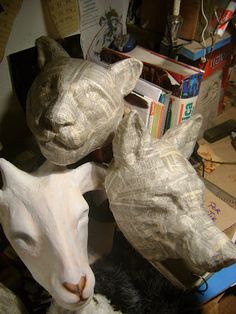 two paper mache animals sitting next to each other