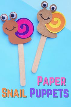 there are two pops with faces on them and the words paper snail puppets above it