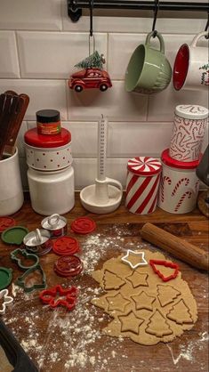 a kitchen counter topped with cookies and cookie cutters