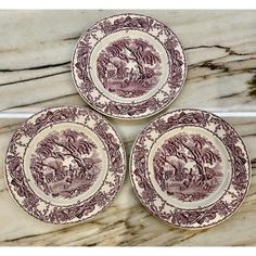 three brown and white plates sitting on top of a marble counter