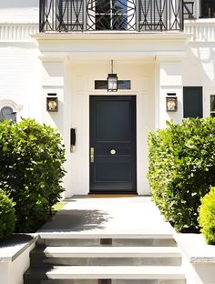 a white house with steps leading to the front door