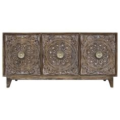 an ornate wooden sideboard with three doors