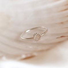 Channel beach vibes whatever the season with our Shell Stacking Ring. The perfect addition to any jewellery box, this simple silver band features a beautifully textured scalloped clam shell to stack high or wear solo. The Seashell symbolises many things across different cultures, including love, peace, fertility, and feminine strength - and will make a meaningful gift for your partner, a friend or even yourself. ~ DESIGN ~ This ring will be made to size for you from 925 sterling silver. The band Silver Shell Rings For Beach, Silver Shell Rings For Gift, Minimalist Sterling Silver Jewelry For Beach, Minimalist Silver Rings For The Beach, Nickel Free Sterling Silver Rings For Beach, Nickel-free Sterling Silver Rings For The Beach, Silver Stackable Jewelry For Beach, Stackable Silver Jewelry For The Beach, Minimalist Beach Ring Jewelry