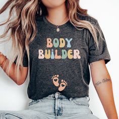 a woman with long hair wearing a body builder shirt