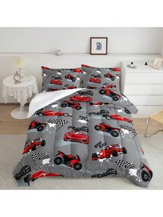 a bed in a room with a red car on the cover and white pillow cases