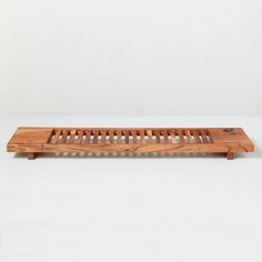 a wooden slatted bench sitting on top of a white table