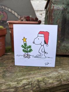 a card with a drawing of a snoopy christmas tree and a star on it