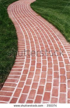 a brick path in the grass