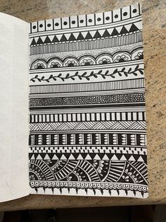 an open notebook with black and white designs on it