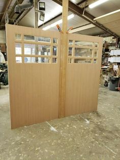 two wooden doors in an unfinished building