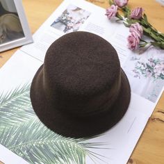 The EMES SHOP hat is detailed with a luxe soft wool material. Features a solid color and bucket hat design.MATERIAL:100% BrushedWool BlendCIRCUMFERENCE MEASUREMENTS: 56-58cm 22-23in Winter Solid Top Hat With Flat Brim, Wool Felt Hat For Winter, Solid Wool Felt Hat For Winter, Solid Wool Fedora Hat, Classic Brown Bucket Hat, Winter Top Hat With Short Brim, Wool Winter Bucket Hat, Classic Winter Bucket Hat, Wool Bucket Hat With Curved Brim For Fall