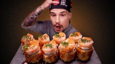 a man is looking at some appetizers on a tray